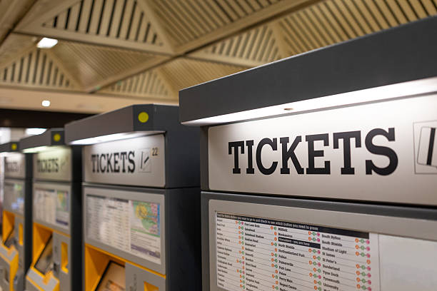 Close-up shot of a row of ticket machines in a metro station in North East England. The main focus is on the top of the machines which indicate 'tickets' can be bought here.\n\nVideos similar to this scenario available.