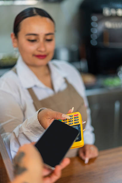 istock Restaurant employee charges customer for the bill using a dataphone to receive payment. 2238746642