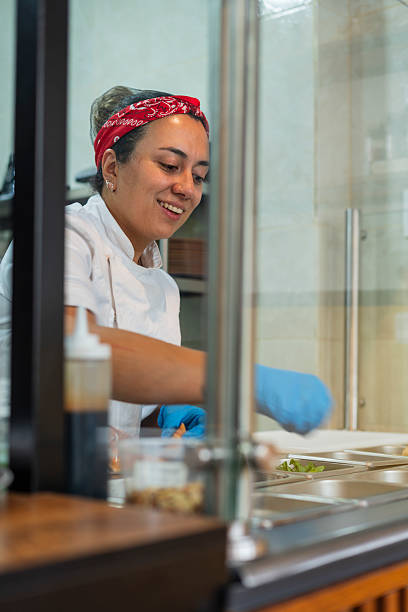 istock Chef starts his workday while organizing the bar toppings wearing his kitchen uniform 2238754384