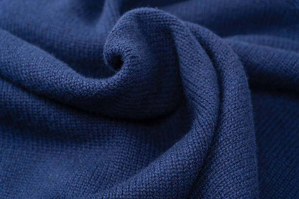 Navy blue merino wool sweater texture as background. Top view.