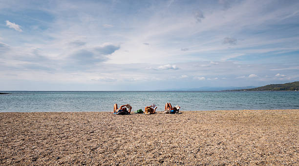 istock Friends Reading Together on the Shore 2238757153