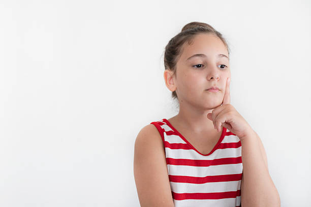 Cute little girl thinking on white background