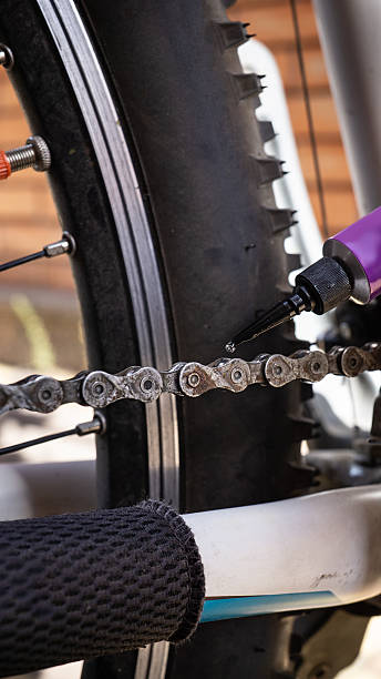 istock Close-up of lubricating a bicycle chain, bicycle maintenance to prevent rust. 2238760002