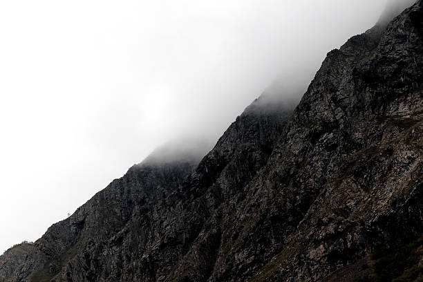 istock Mountain peak shrouded in thick clouds. The rocky surface is partially visible, creating a dramatic and mysterious atmosphere. 2238760877
