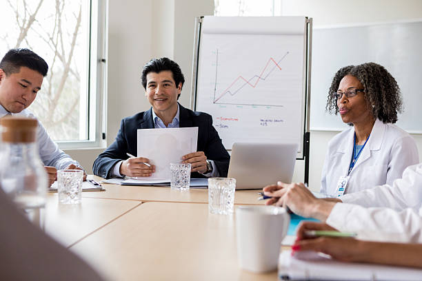istock Healthcare professionals in a meeting discussing a chart with progress and data. 2238761428