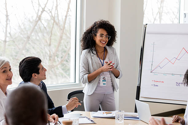 istock Diverse business professionals collaborate and discuss financial reports in a modern office meeting. 2238761437