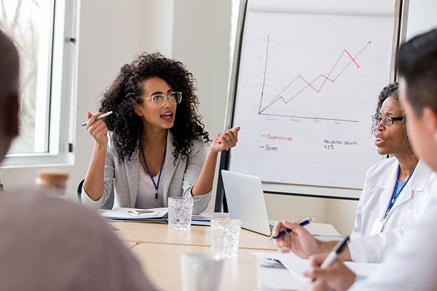 istock Team discusses sales expenditures and projected growth in a professional meeting. 2238761469