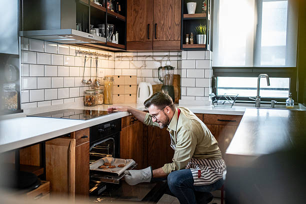 istock Man baking homemade chocolate chip cookies in modern kitchen 2238761877