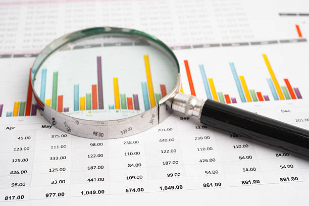 istock Magnifying glass on data business graphs paper. 2238762547