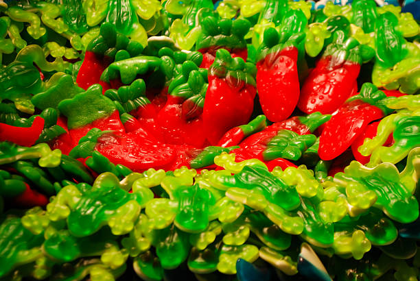 Colorful selection of assorted gummy and jelly candies arranged in bulk bins at a candy store in Prague, Czech Republic. A vibrant food background showcasing sweets, sugar, and confectionery treats.
