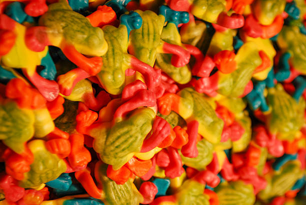 Close-up photo of a candy store display featuring gummies and jelly candies in bright colors. Photographed in Prague, Czech Republic, highlighting confectionery culture and sugar treats.