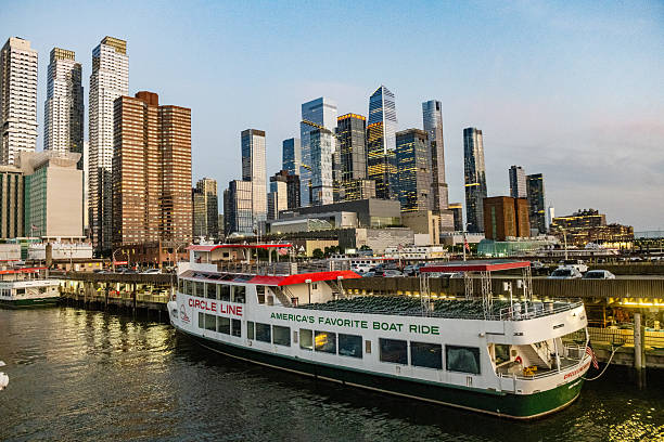 The Piers at the shore of Hudson river, Intrepid aircraft carrier museum, a transatlantic and the skyline of Hells Kitchen, Manhattan, New York City, USA