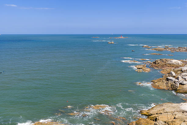 Looking down at the waves crashing against the rocks