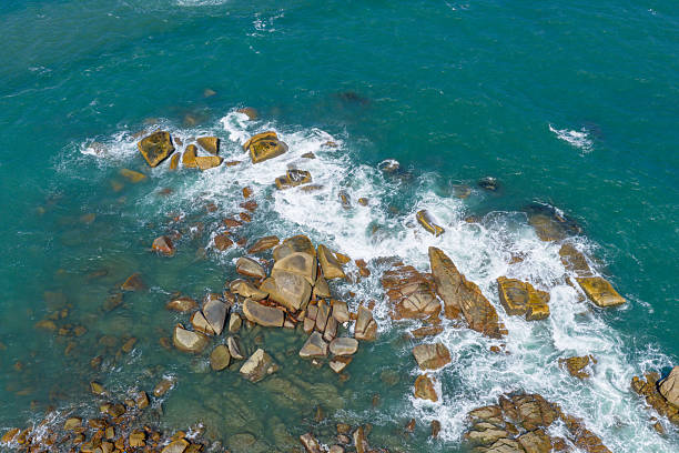 Looking down at the waves crashing against the rocks