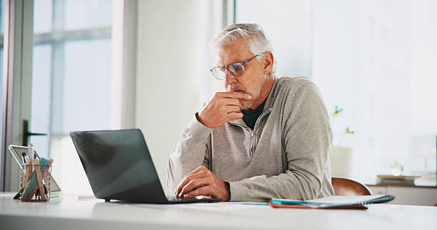 istock Thinking, CEO and man with laptop, office or planning for UX design on website, creative and online. Reflection, graphic designer and mature person with solution for project, serious and research 2238768070
