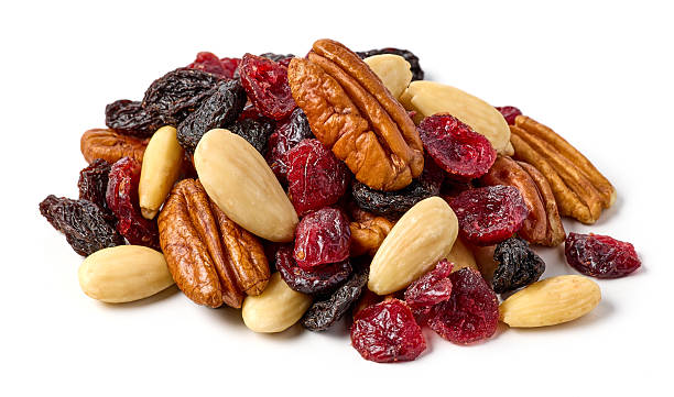 A pile of shelled hazelnuts, walnuts,cashew nuts and almonds, isolated on a white background.