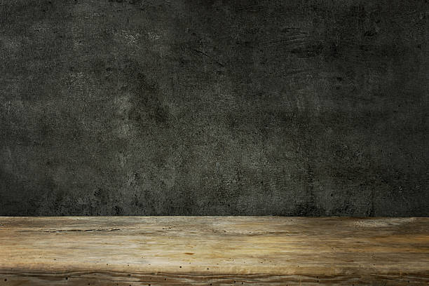 istock wooden table and black wall 2238768289
