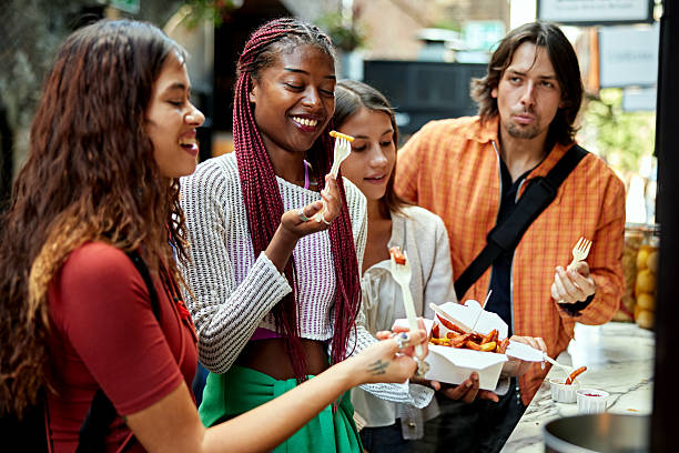 istock Friends taking a break for street food 2238770041