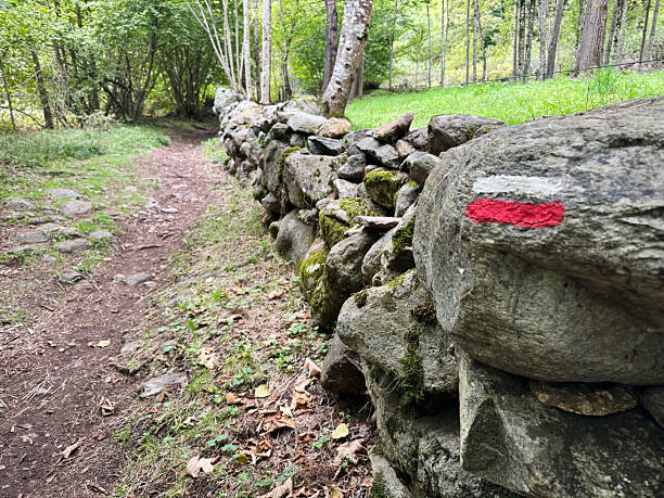 Long distance foot path marking on a dry stone wall on a walking trail through the Pyrenees