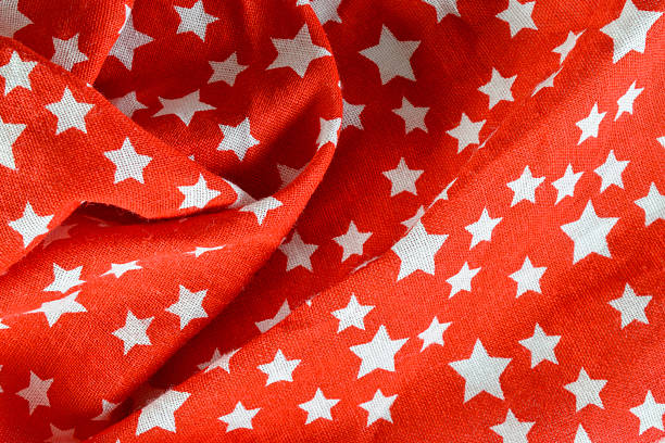 Close-up of cheerful star fabric  in red and white. Ideal for backgrounds, banners, and editorial use.
