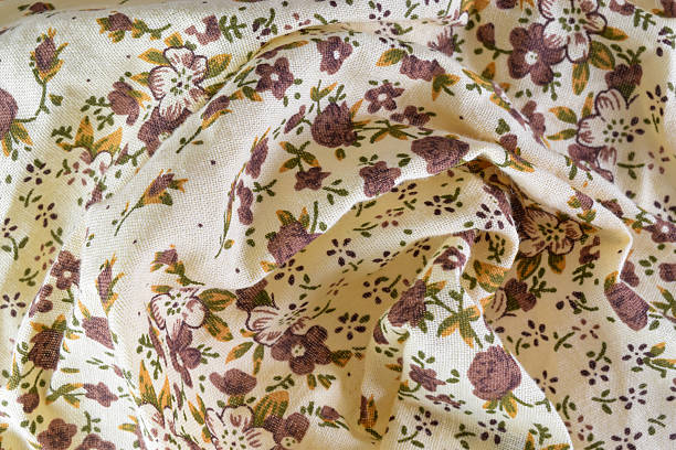 A close-up texture of a classic floral print with small pink, purple, and white flowers. Suitable for textiles and backgrounds.