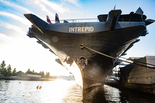 August 1st, 2025: New York City, United States - The Intrepid museum remains docked along the Hudson River as kayakers paddle nearby on a summer day.