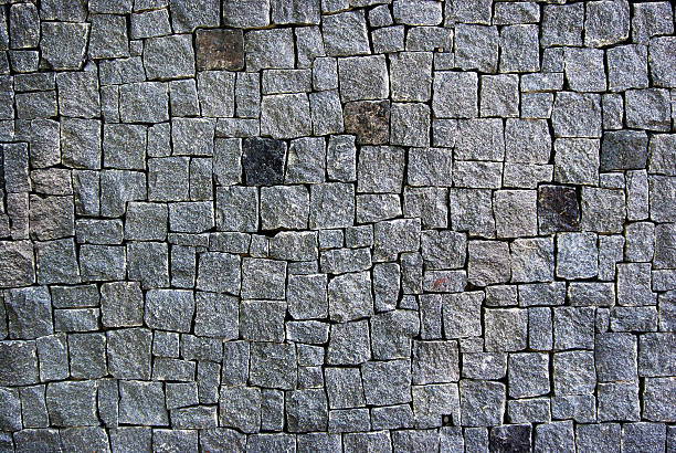 istock stone wall texture background. wall of gray granite blocks 2238774406