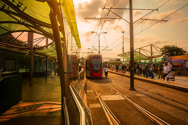 Manila, Philippines - April 19, 2012: LRT light rail transit system stop in metro Manila. Two trains pass each other. The driver of the approaching vehicle can be seen through the glass.