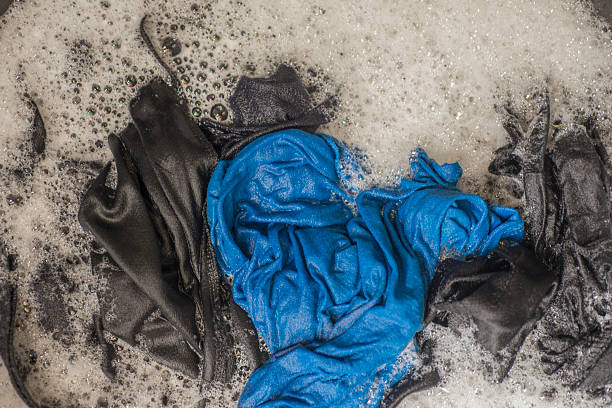istock Laundry washed clothes in washing machine with foam. Top view 2238775470