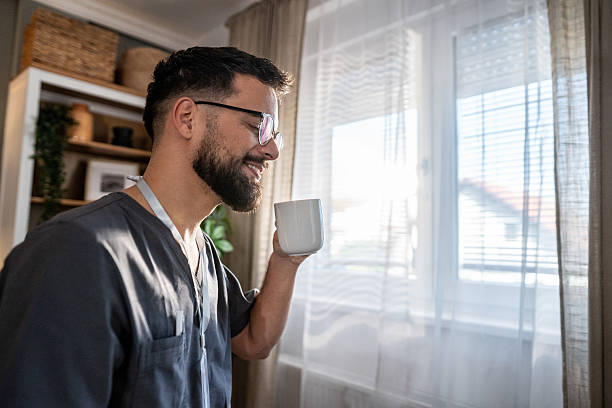 istock Male healthcare worker drinking coffee during break 2238776439