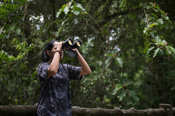 istock Woman Bird Watching in the Grassland with Binoculars 2238776540