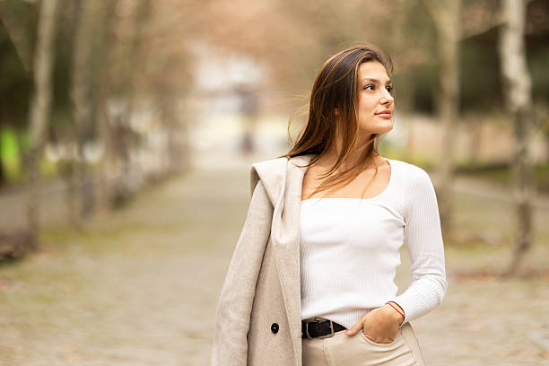 istock Young woman looking away thinking outdoors 2238780933