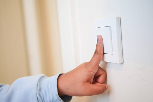 istock Child turning off light switch in living room during daylight hours 2238786973