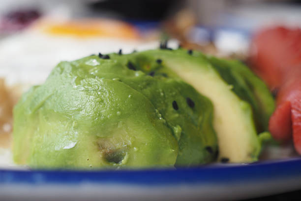 Freshly prepared avocado served on a vibrant plate during breakfast.
