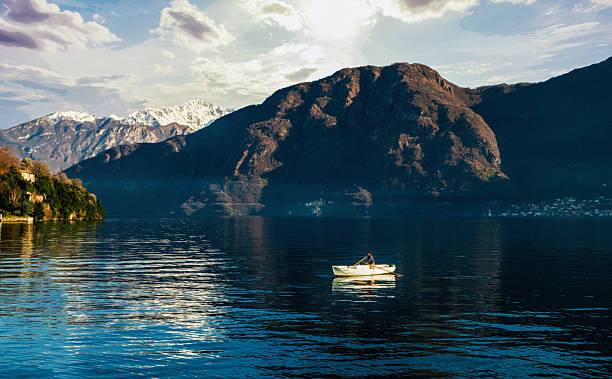 istock Fisher (blurred motion) on lake Como in boat 2238790585