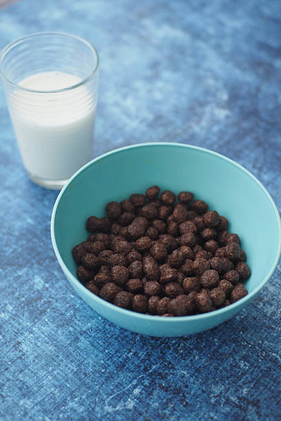 istock Chocolate cereal in a blue bowl with milk on a blue background 2238791066