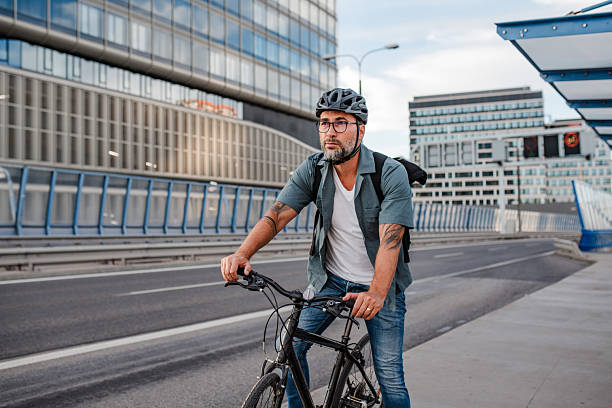 istock Urban commuter cycling on street carrying backpack. 2238792097