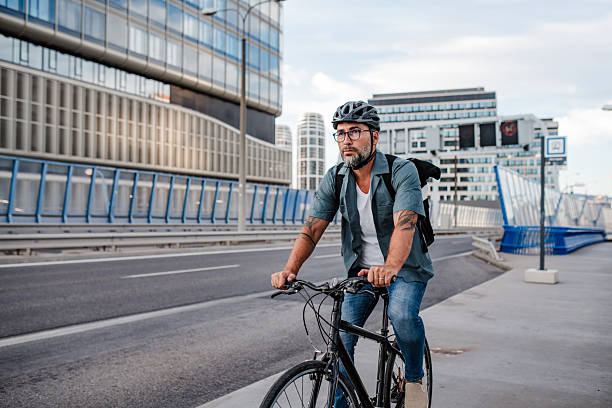 istock Urban commuter cycling on street carrying backpack. 2238792147