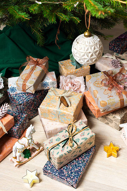 istock A cozy Christmas scene with elegant natural-toned gift boxes placed under a Christmas tree, lit with festive lights, evoking peace and seasonal joy 2238792540