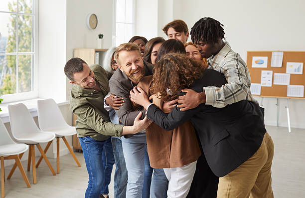 istock Diverse Group of People Embracing at Office 2238794458
