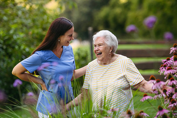 istock Home nurse spending time with elderly lady patient in garden. 2238795382