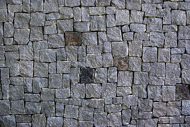 istock stone wall texture background. wall of gray granite blocks 2238797018