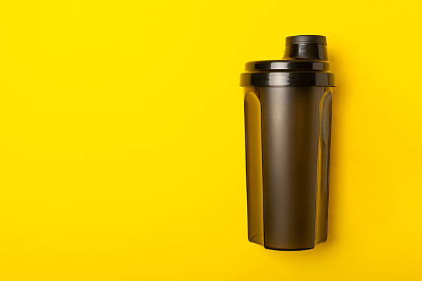 istock Protein shake with protein powder on a colored background. The powder is mixed with water or milk. A dietary supplement for a balanced diet. Whey protein. Fitness and gym diet nutrition. 2238798992