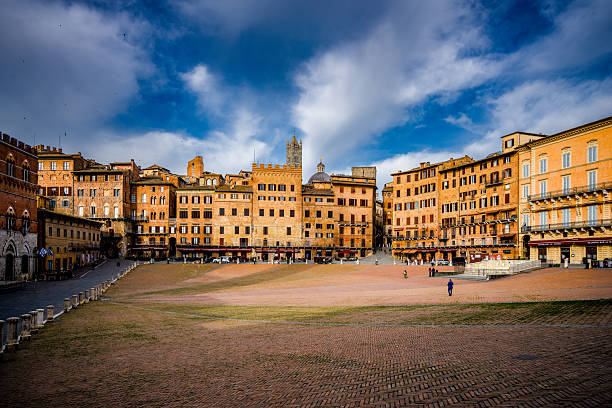 Wide view of Piazza del Campo in Siena, Italy, photographed on April 30, 2025, with historic buildings and the Torre del Mangia rising above the square.