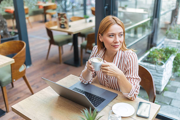 istock Young Woman Relaxing with Laptop and Coffee 2238802994