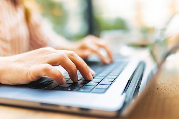 istock Young Unrecognisable Woman Working on Laptop in Cafe 2238803000