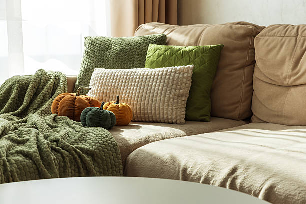 istock Cozy Autumn Sofa with Fabric Pumpkins and Textured Pillows 2238806527