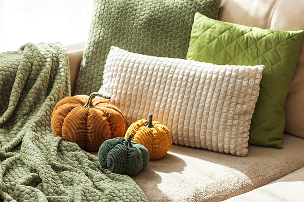 istock Cozy Autumn Sofa with Fabric Pumpkins and Textured Pillows 2238806528