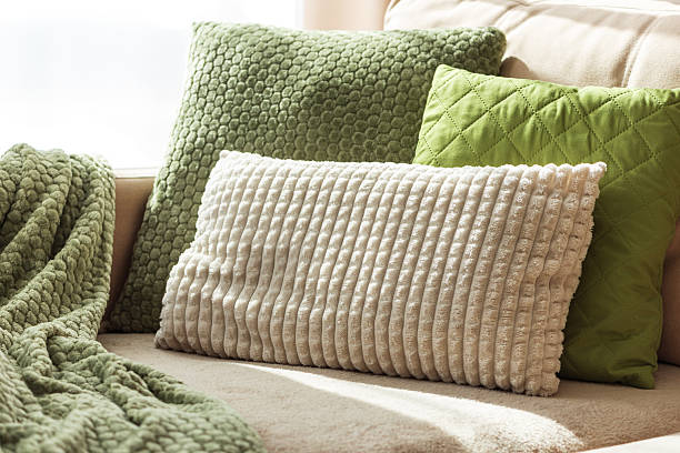 istock Textured Pillows and Blanket on Cozy Beige Sofa 2238806531