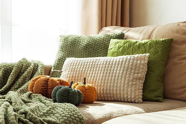 istock Cozy Autumn Sofa with Fabric Pumpkins and Textured Pillows 2238806533